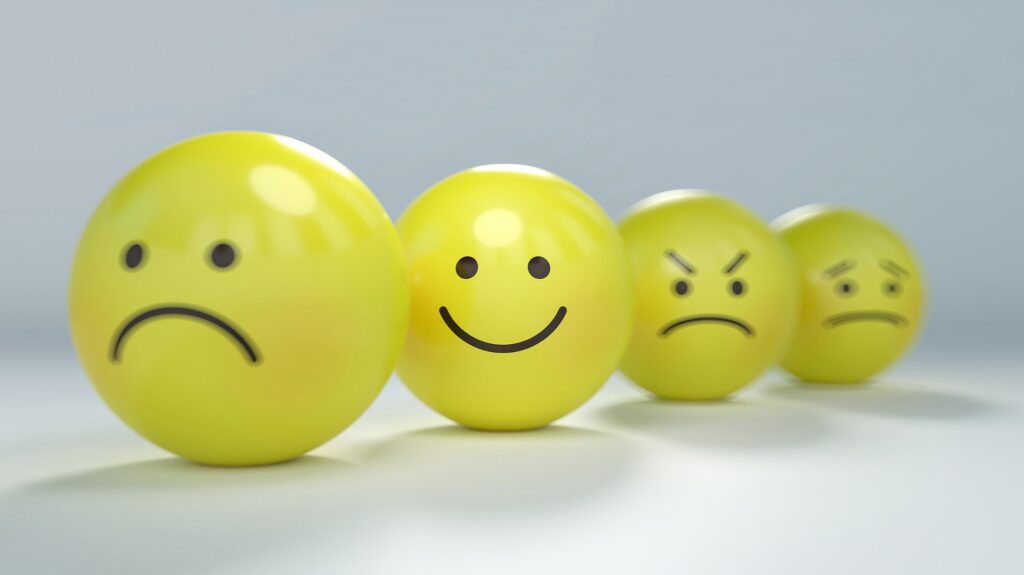 Yellow balls with variety of expressions, sad, happy, mad