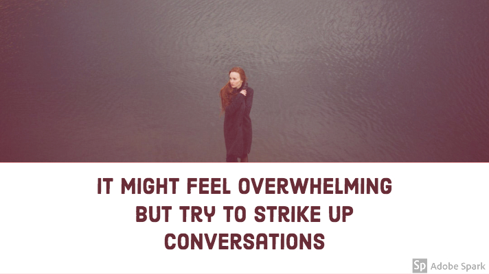 A woman with red hair, holding her coat by her neck to keep warm, stood alone by a body of water. Quote underneath says "It might feel overwhelming but try to strike up conversations"