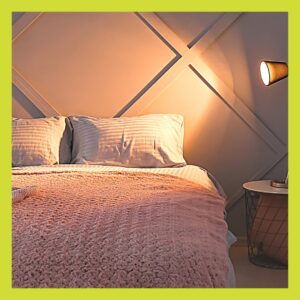 Cody looking double bed in the light of a lamp