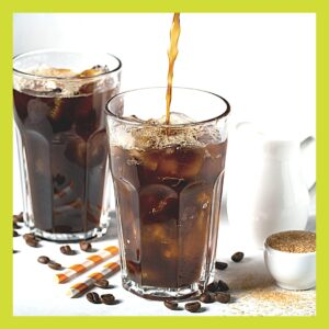 Two glasses of cola with ice, one still being poured