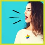 Woman with rainbow star badge speaking out