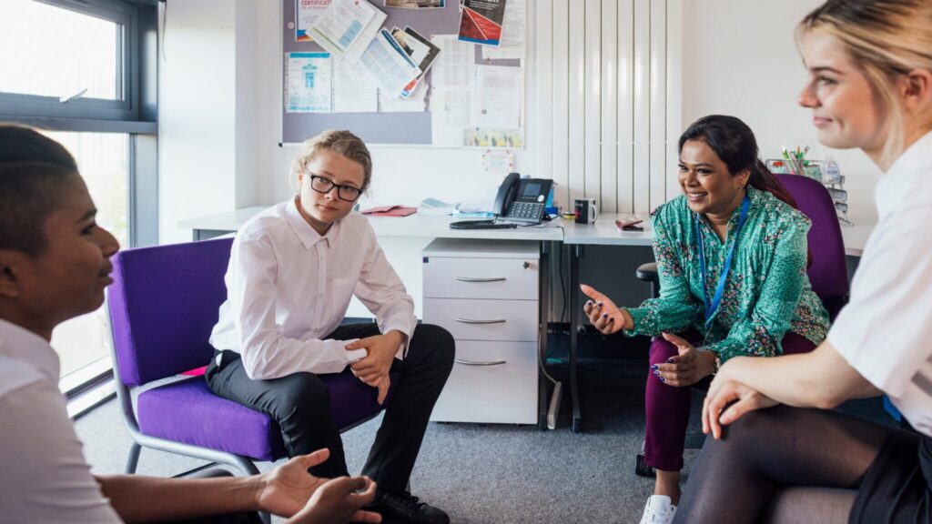 2 students and 2 teachers sat together in a side classroom, talking together
For GCSE options blog