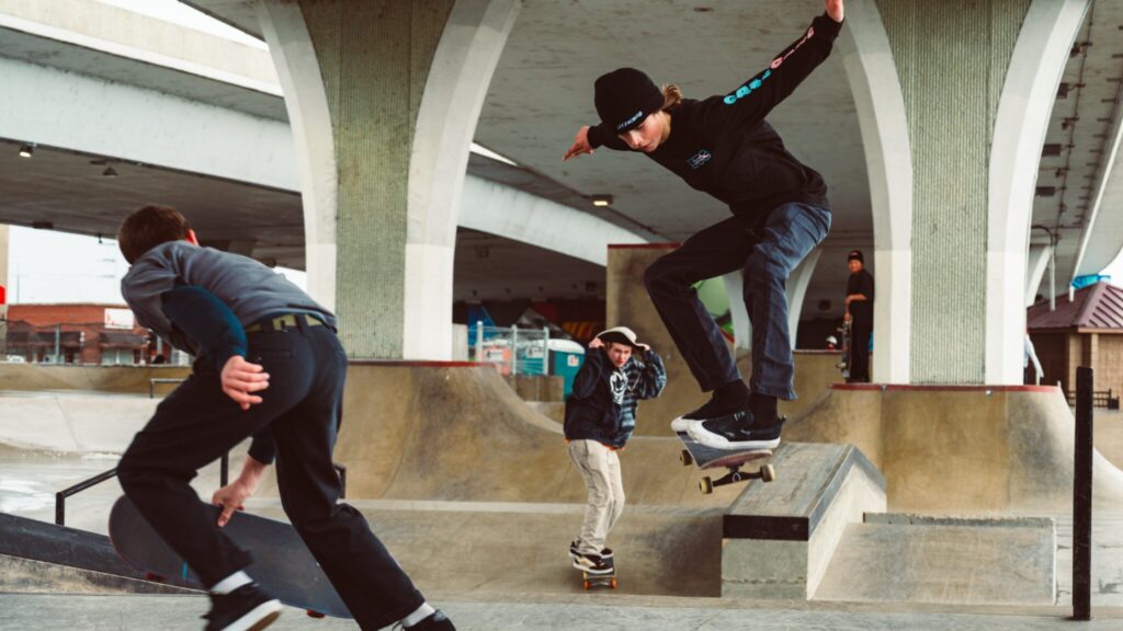 Teenage boys practising their skateboarding skills in the skatepark