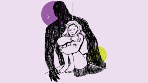 A young girl crouched in a corner with a figure shadowing over her