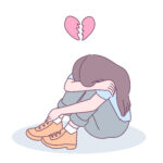 A heartbroken girl sat with head in lap with broken heart hovering over head