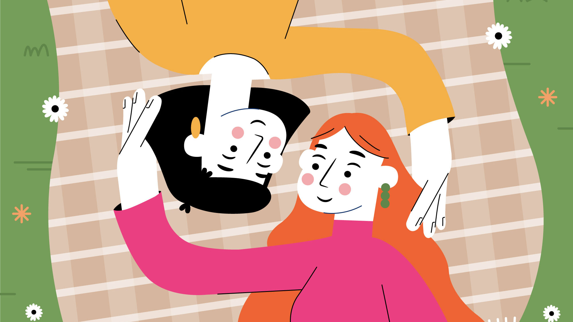 Two women, one with red hair and one with black hair laying on a picnic blanket together