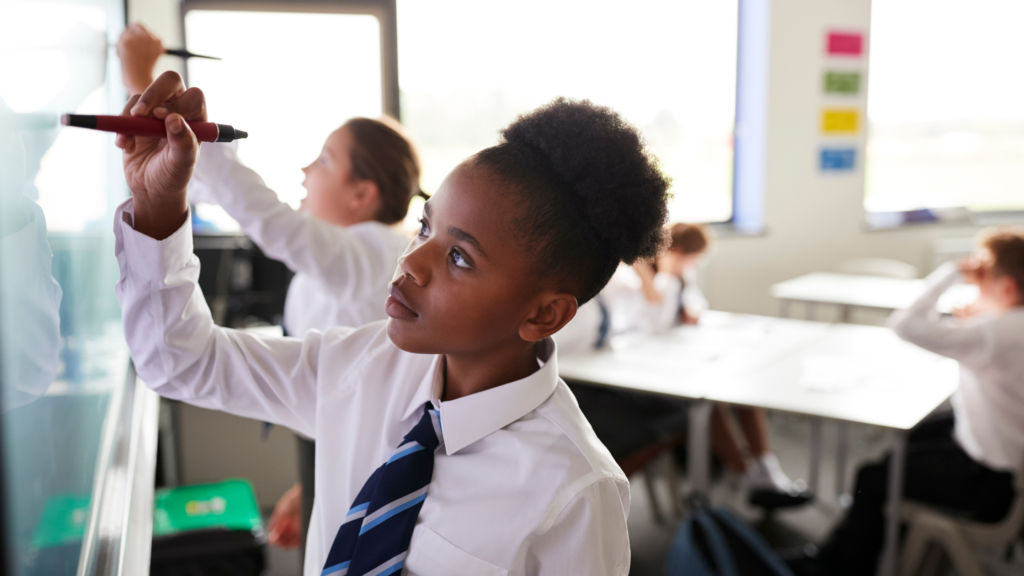 Young girl in UK classroom drawing on an interactive whiteboard with a magic pen
For GCSE options blog