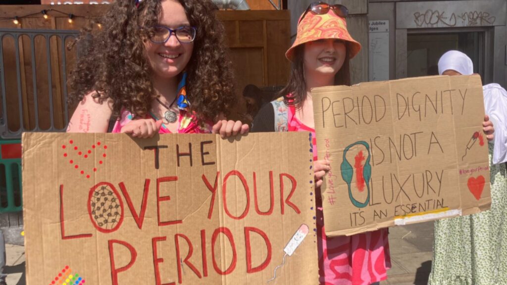 Placards held by members of the Love Your Period Campaign. 