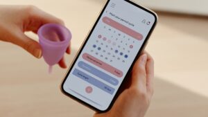 Someone using a calendar to track their periods on a phone app