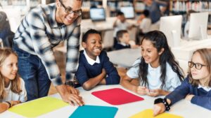 teacher talking to a table of students
