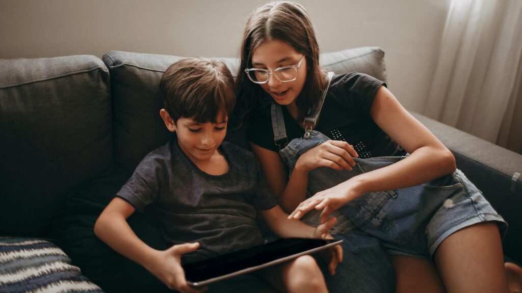Siblings sat together on the sofa