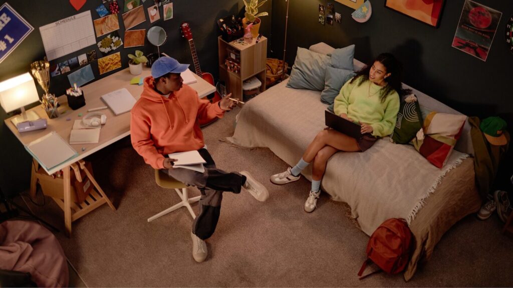 Two teens revising together in bedroom
