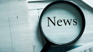 Magnifying glass on newspaper