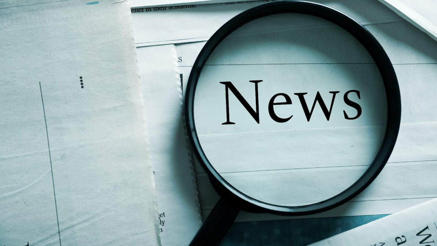 Magnifying glass on newspaper