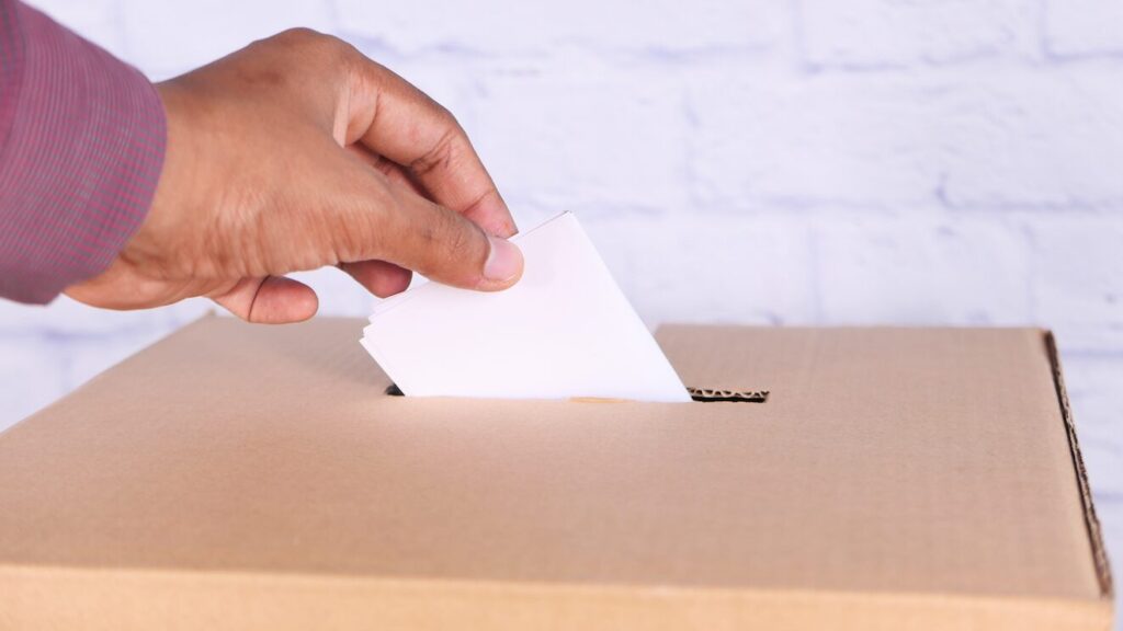 Person casting their vote in an electon