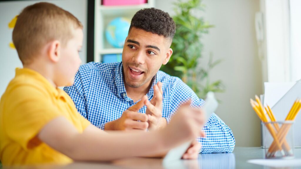Child talking to a teacher