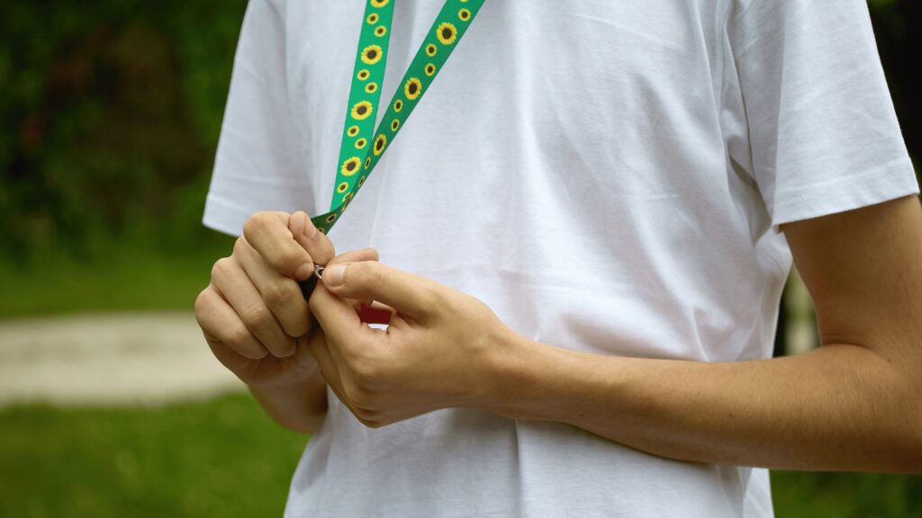 Teen boy wearing a sunflower lanyard