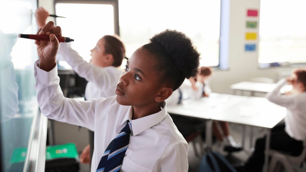 Teen wearing UK school uniform in classroom