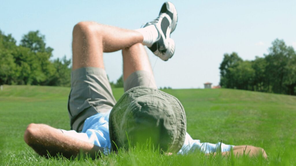 Teen chilling out laying on the grass