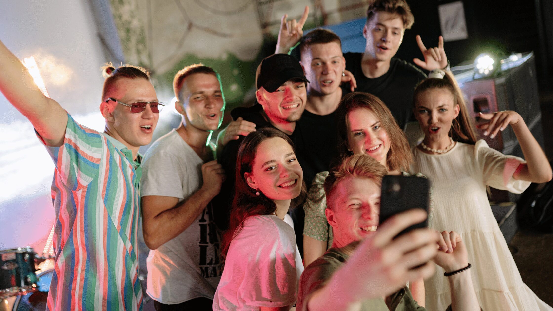 Groups of teens posing for a group photo at a festival