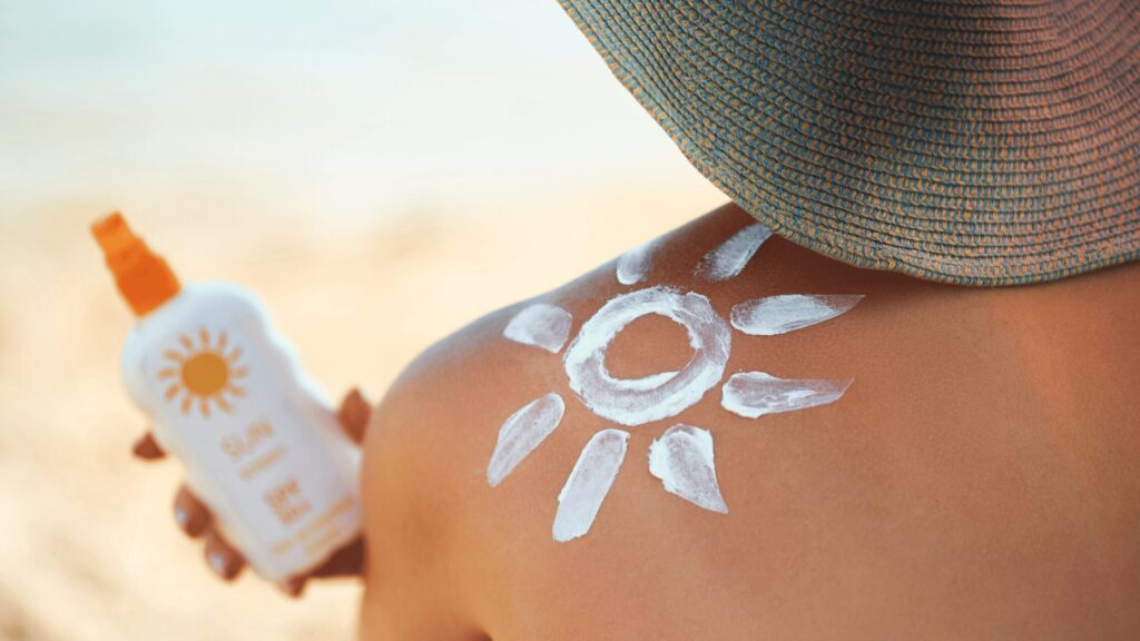 Person applying suncream at a festival