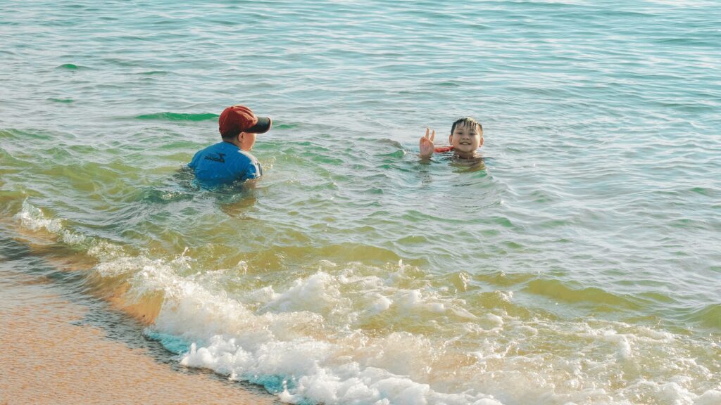 Two children playing in the shallow end of the sea