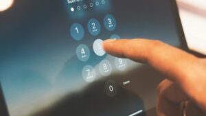 Person unlocking their ipad by entering a passcode