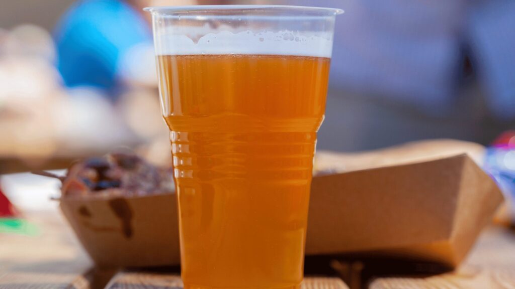Pint of beer on a picnic table at a festival